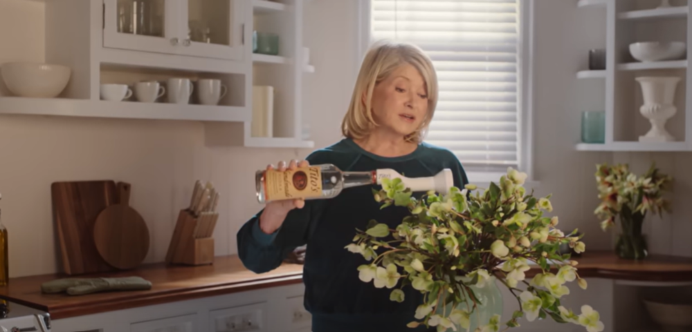 Martha Stewart waters her flowers with a bottle of Tito's