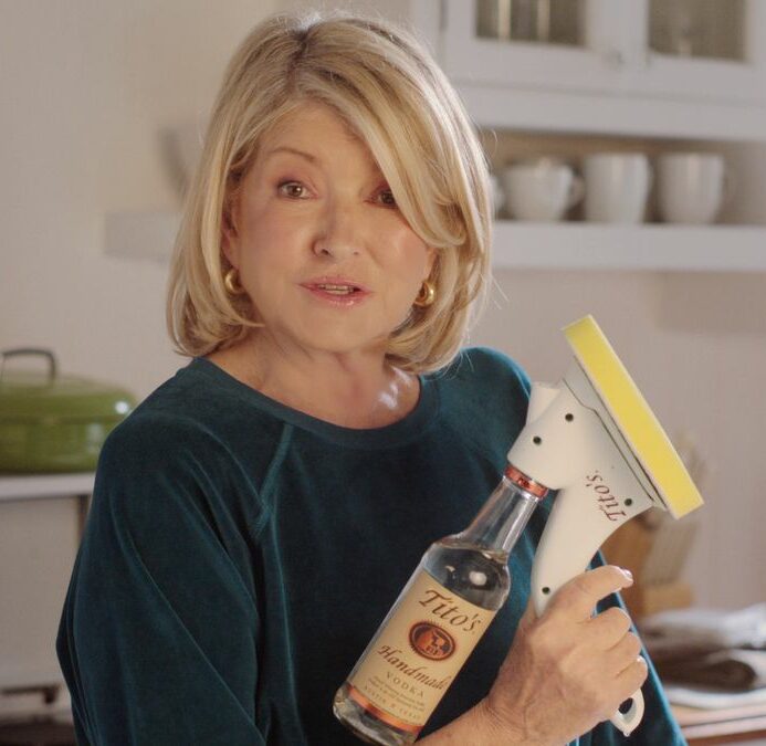 Martha Stewart cleaning with a bottle of Tito's